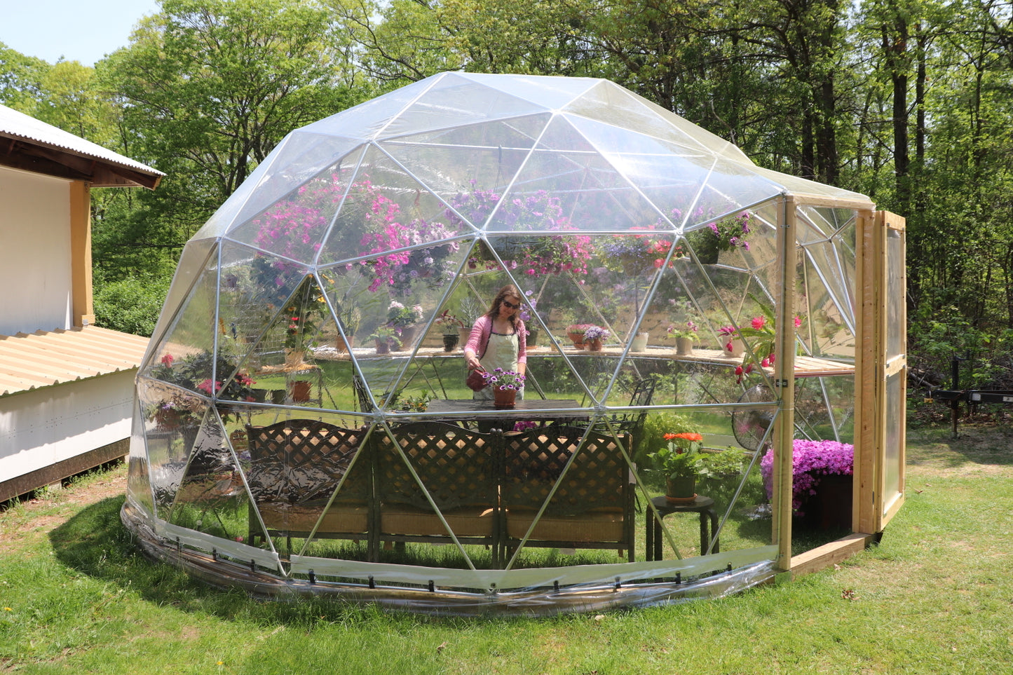 Outside profile photo of a 16 ft greenhouse dome with a clear vinyl cover.